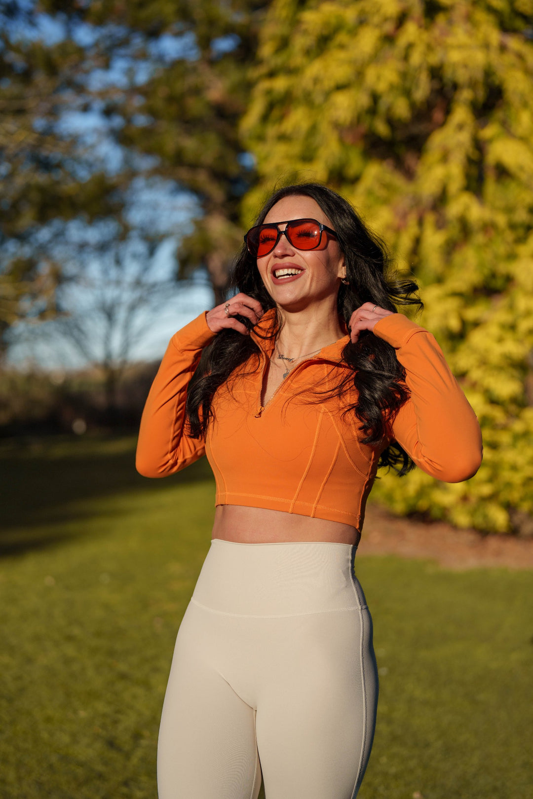 Orange Sculpt Zip Top worn by Nicole outdoors